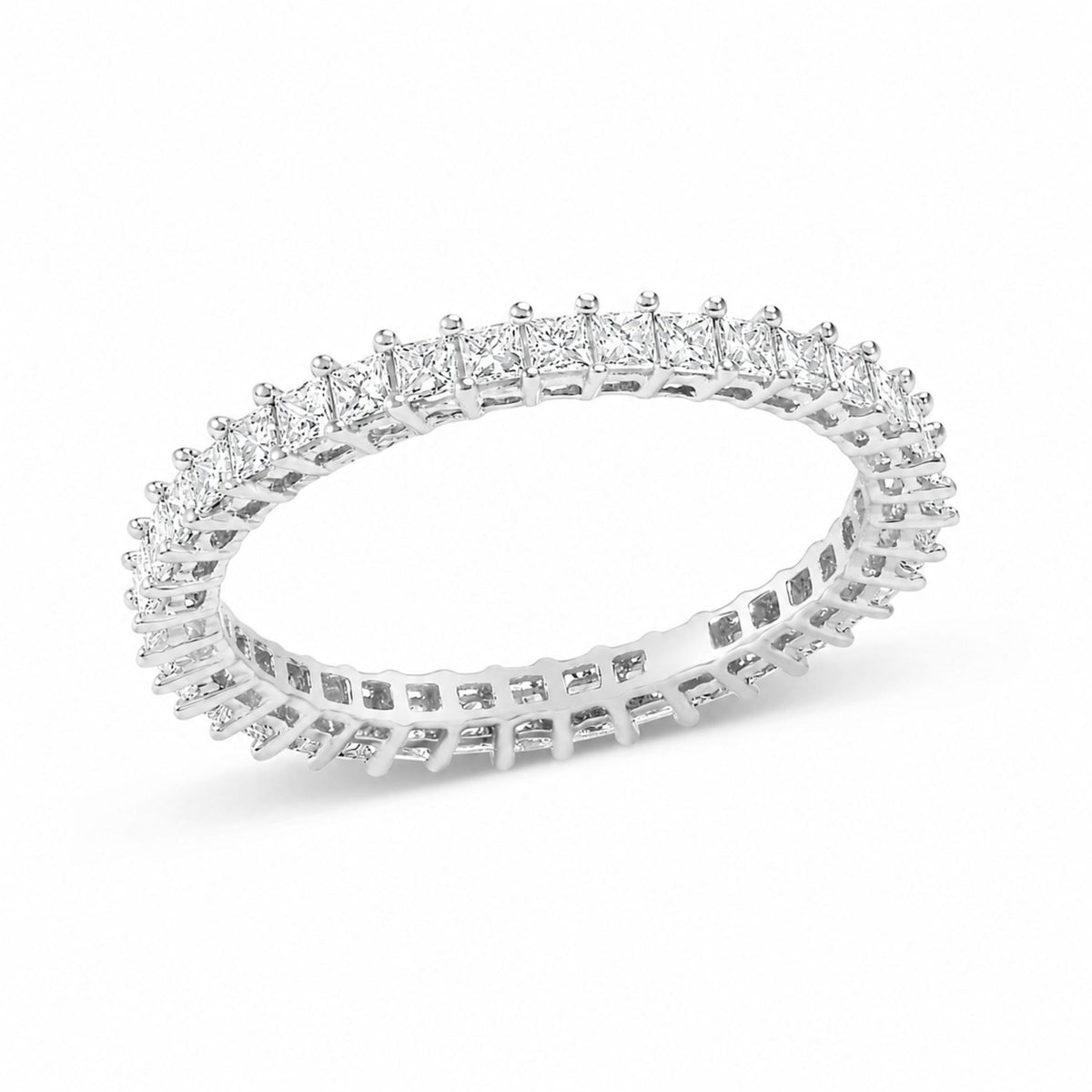 Close-up front angled view of a white metal ring featuring a continuous row of princess-shaped white gemstones set with prongs.