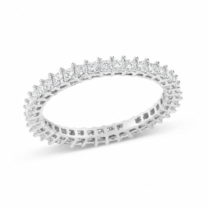 Close-up front angled view of a white metal ring featuring a continuous row of princess-shaped white gemstones set with prongs.
