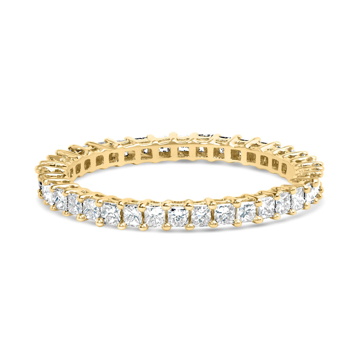 Close-up angled view of a yellow metal ring featuring a continuous row of white princess-shaped gemstones in prong settings around the band.