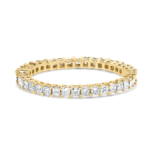 Close-up angled view of a yellow metal ring featuring a continuous row of white princess-shaped gemstones in prong settings around the band.