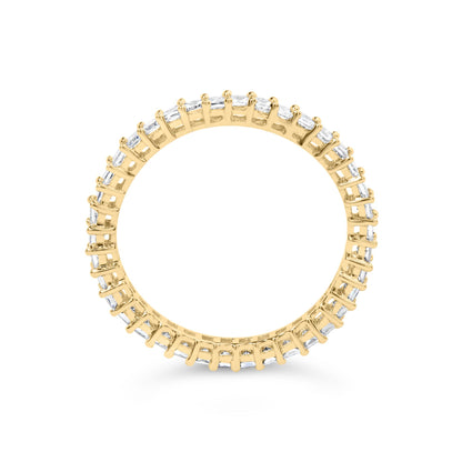Close-up front angle of a yellow ring featuring a continuous row of white princess-shaped gemstones in prong settings.