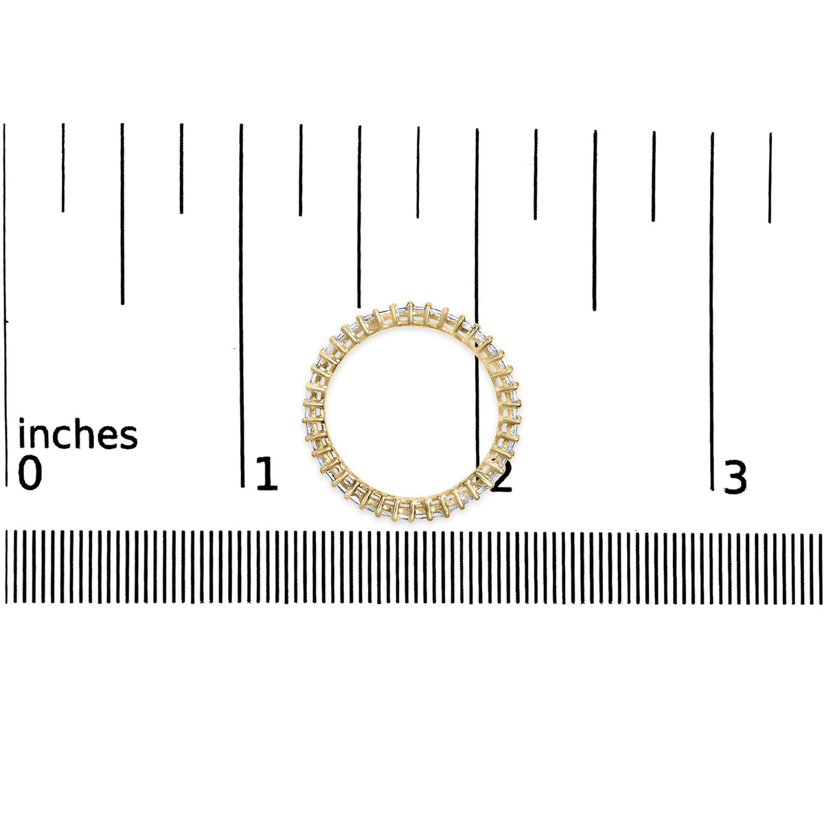 Top-down view of a yellow ring with a continuous row of white princess-shaped gemstones in prong settings, shown on a scale background.