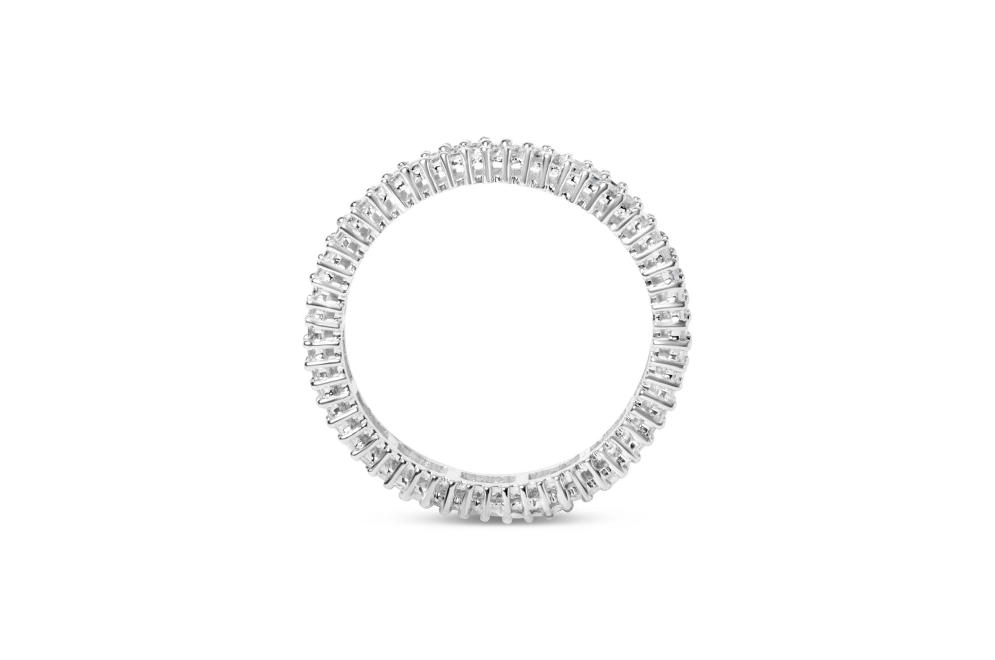 Top-down view of a white metal ring fully encircled with white princess-shaped gemstones in prong settings.
