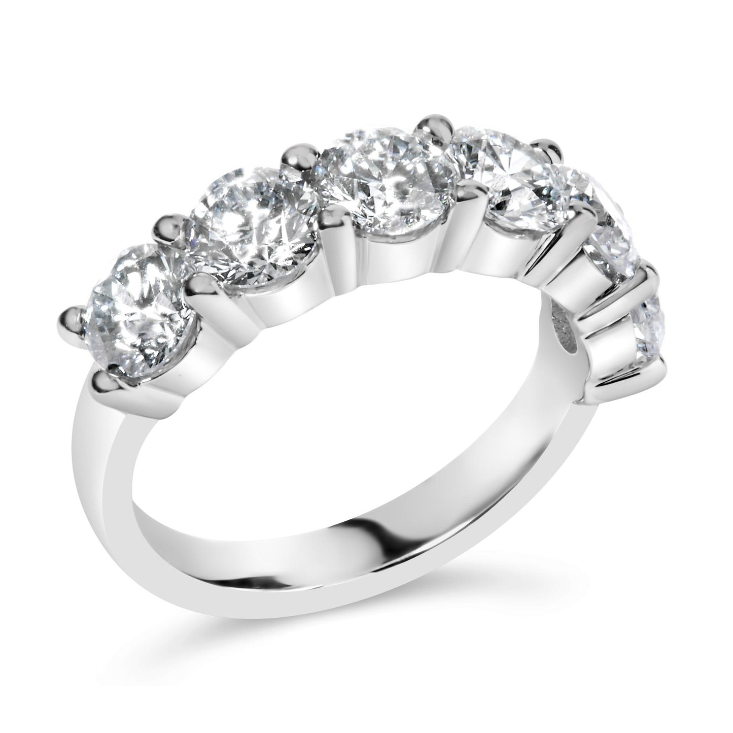 White metal ring with a row of round white gemstones in shared prong settings, shown at a slight angle.