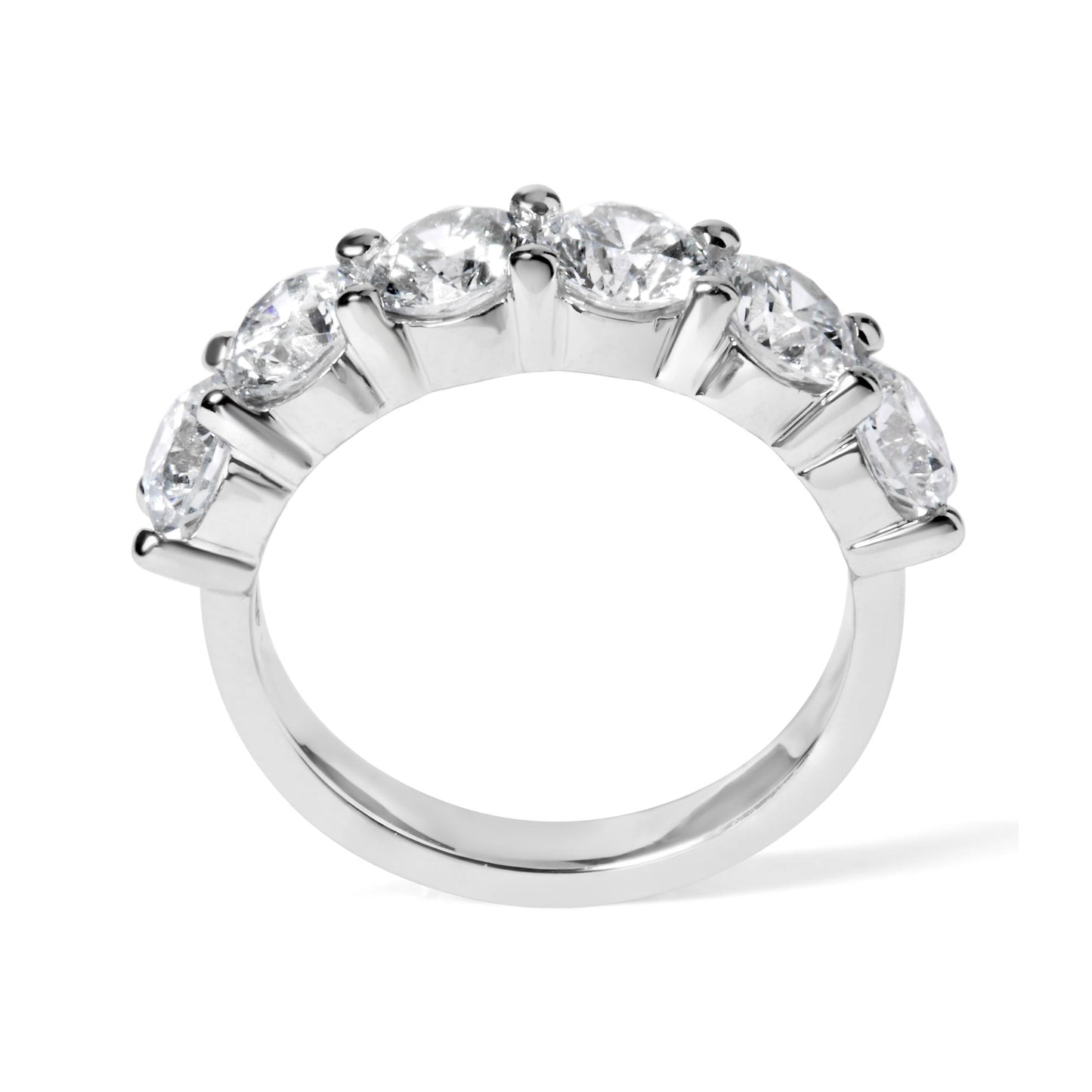 Close-up front angle of a white ring featuring a row of six round white gemstones in a shared prong setting.