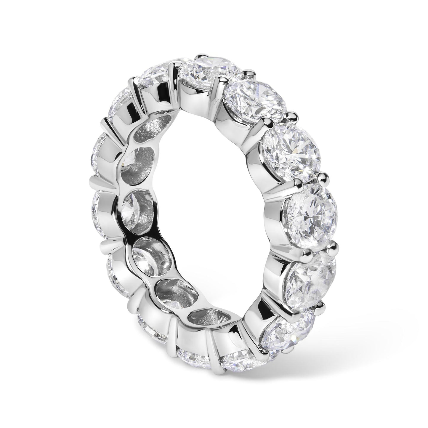 White metal eternity ring with round white gemstones in shared prong setting, shown at a slight angle.