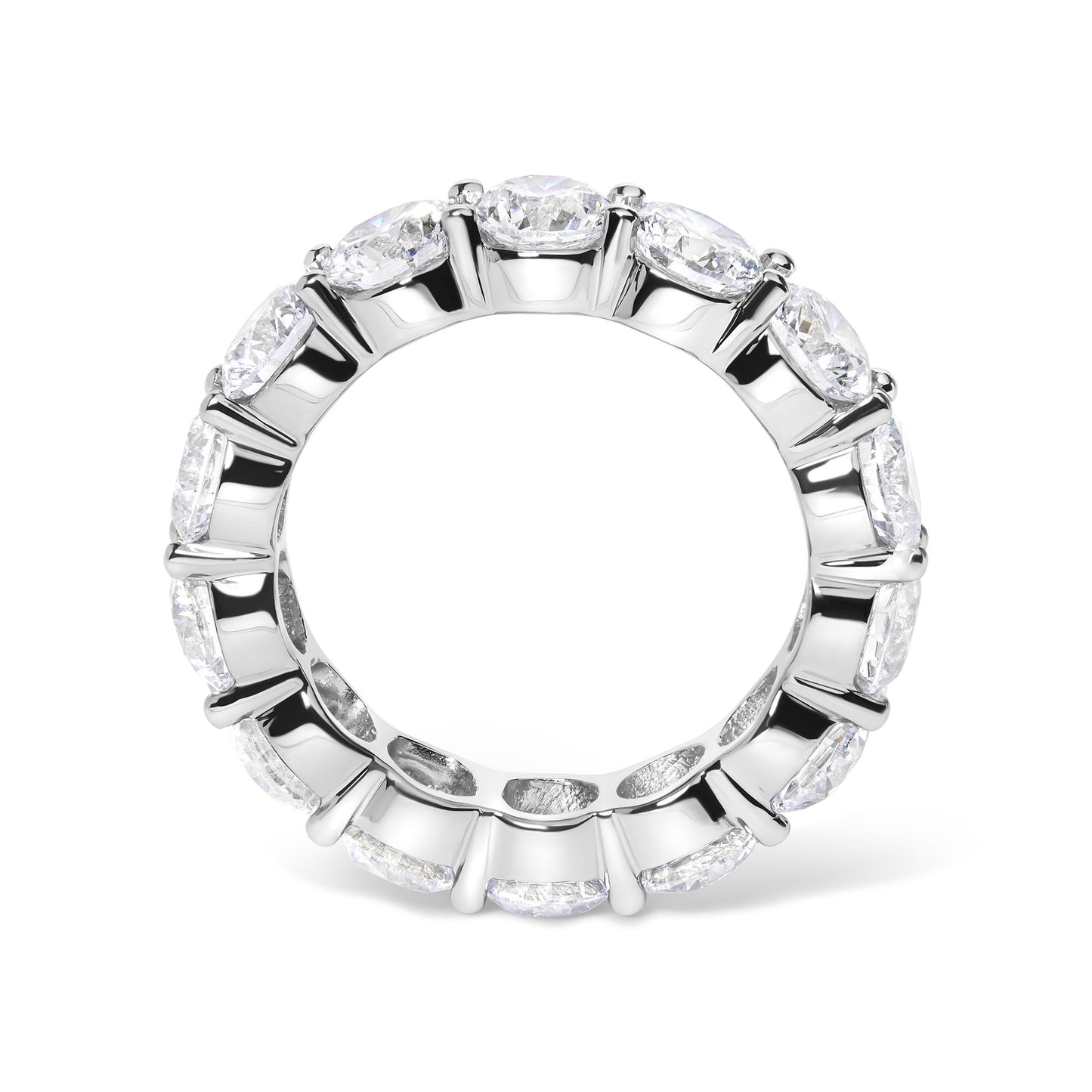 Top-down view of a white metal ring featuring a continuous row of round white gemstones in shared prong settings encircling the band.
