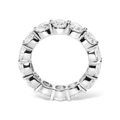 Top-down view of a white metal ring featuring a continuous row of round white gemstones in shared prong settings encircling the band.