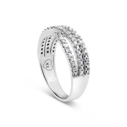 White metal ring with three rows of prong-set princess shape white gemstones, shown at a side angle.