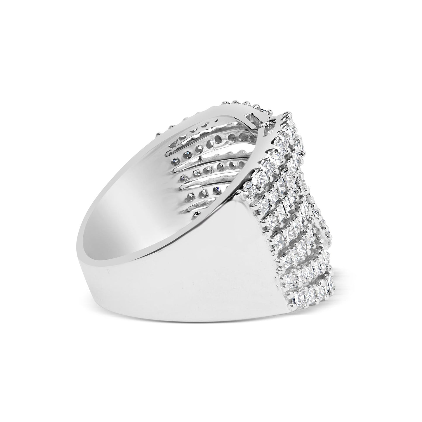 Side view of a white metal ring featuring rows of princess-shaped white gemstones in an invisible setting and round-shaped white gemstones in prong settings on the top front.
