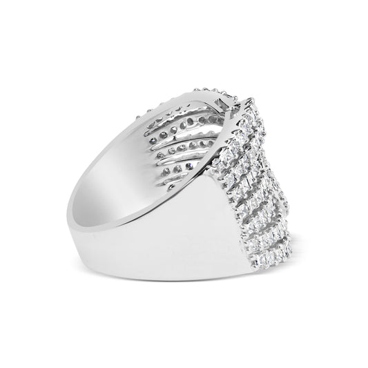 Side view of a white metal ring featuring rows of princess-shaped white gemstones in an invisible setting and round-shaped white gemstones in prong settings on the top front.