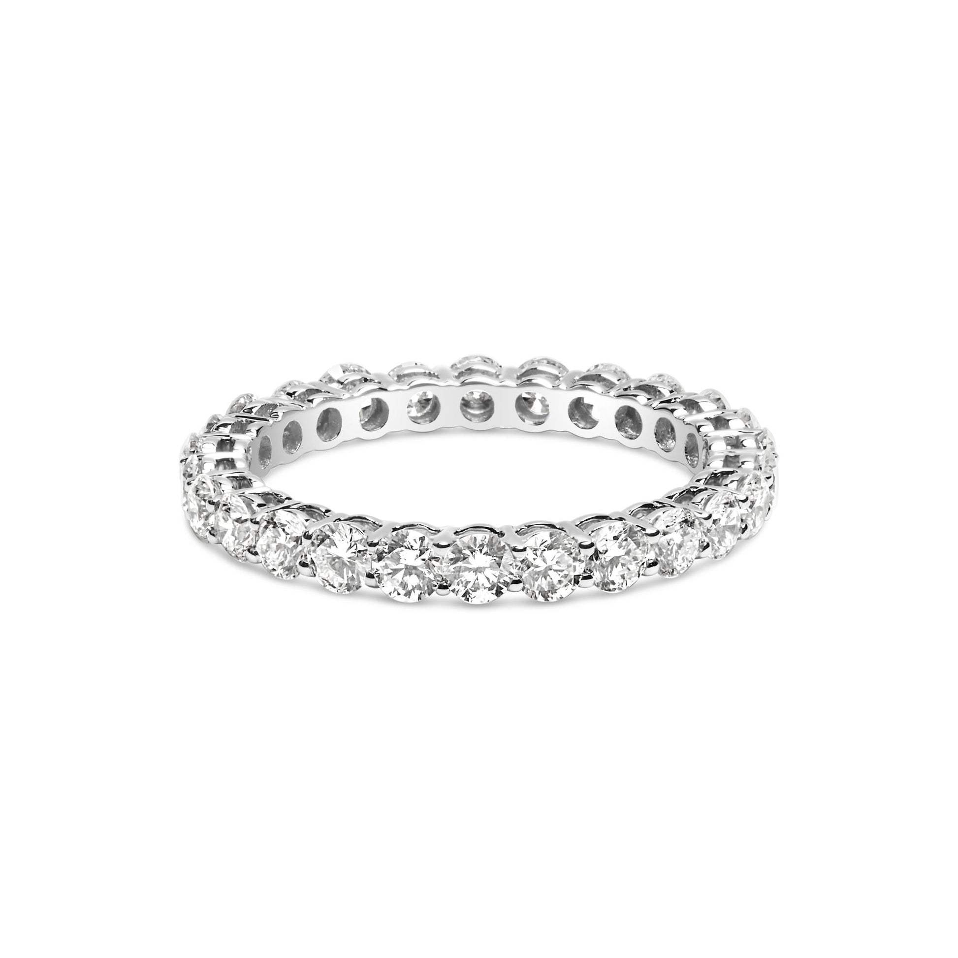 White metal eternity band ring with round white gemstones in prong settings, shown from a front angle.