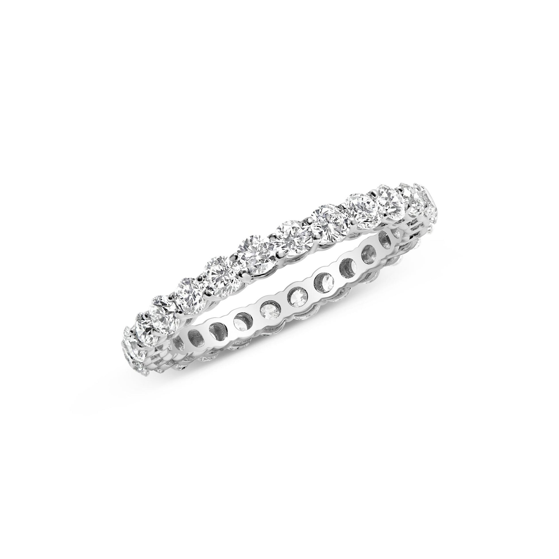 Close-up angled view of a white metal ring with a continuous row of round white gemstones in prong settings around the band.