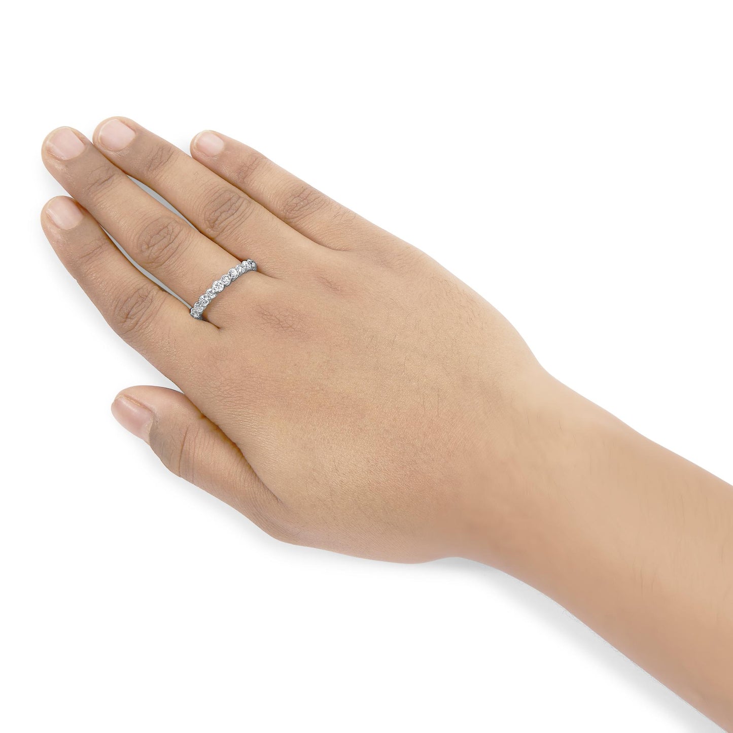 White metal ring with round white gemstones in prong settings, worn on a hand, shown from a top-side angle.