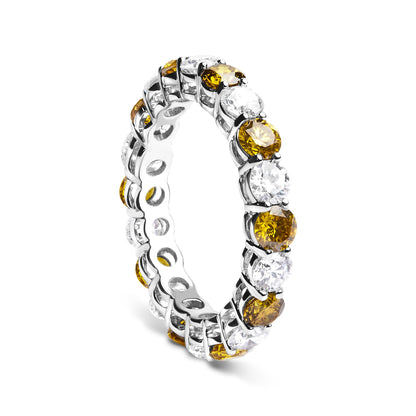White metal eternity ring with alternating round yellow and white gemstones in prong settings, shown at an angled side view.