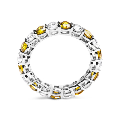 Close-up front angle of a white metal ring set with alternating round yellow and white gemstones in prong settings all around the band.