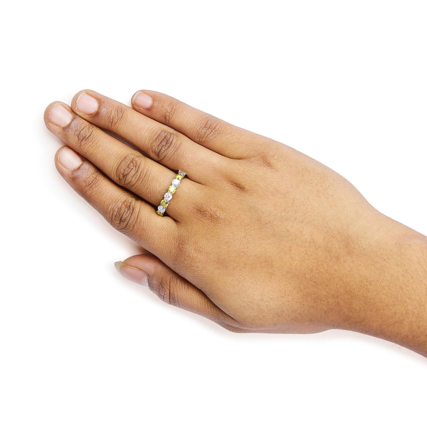 White metal ring with alternating yellow and white round gemstones in prong settings, worn on a model's hand shown from above at an angle.