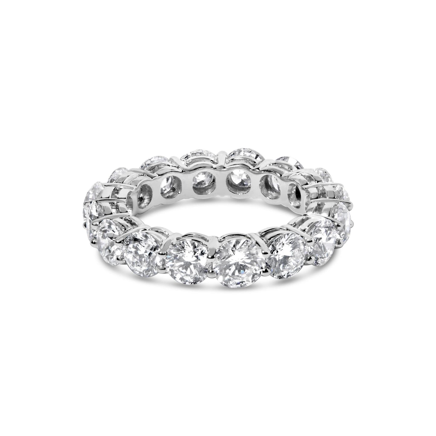 White metal ring with round white gemstones in prong settings all around, shown from a slightly elevated front angle.