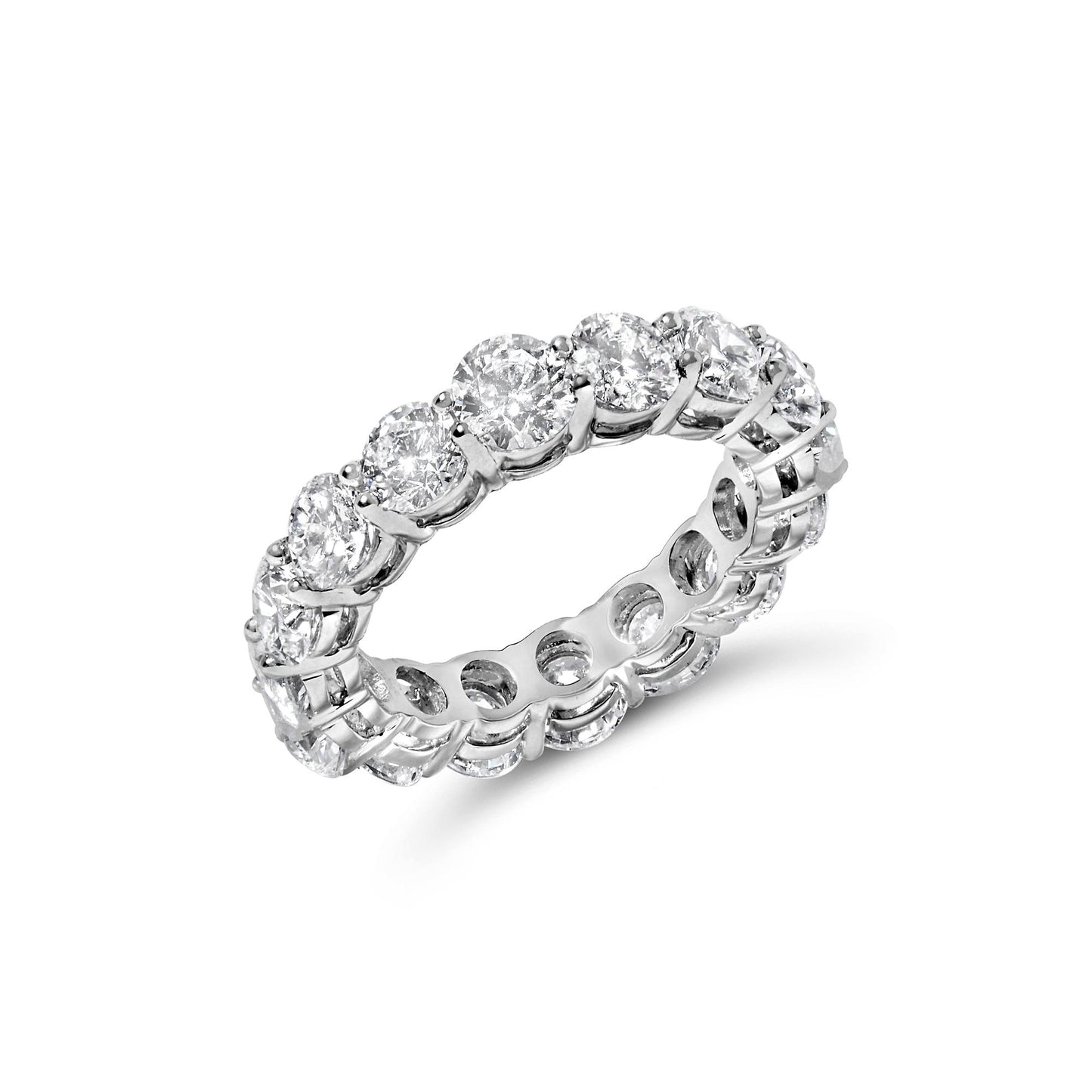 White metal eternity ring with round white gemstones in prong settings, shown at an angled close-up.