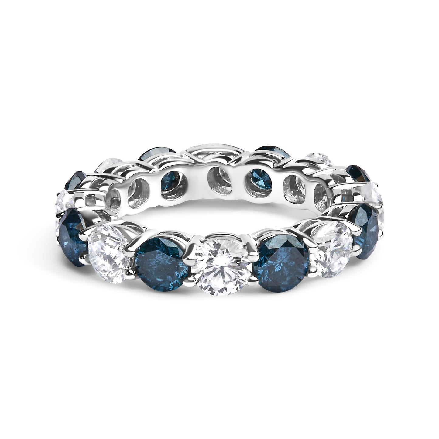 White metal ring with alternating round blue and white gemstones in a shared prong setting, shown from a front angled side view.
