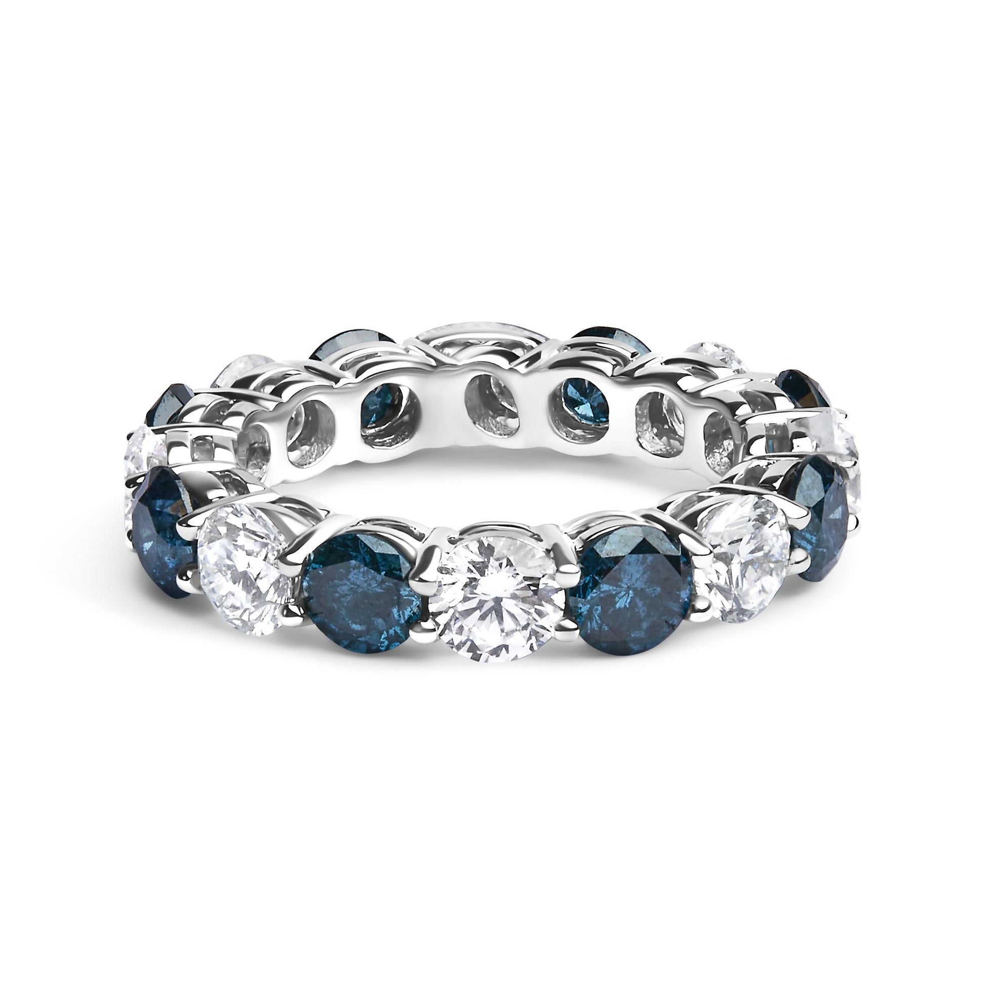 White metal ring with alternating round blue and white gemstones in a shared prong setting, shown from a front angled side view.