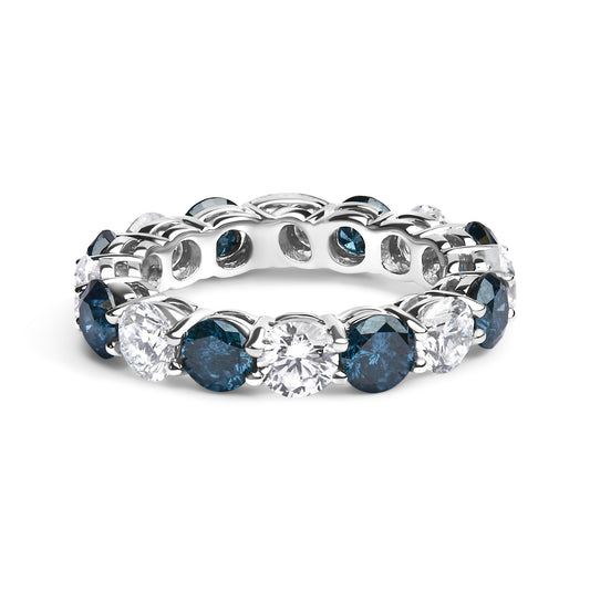 White metal ring with alternating round blue and white gemstones in a shared prong setting, shown from a front angled side view.