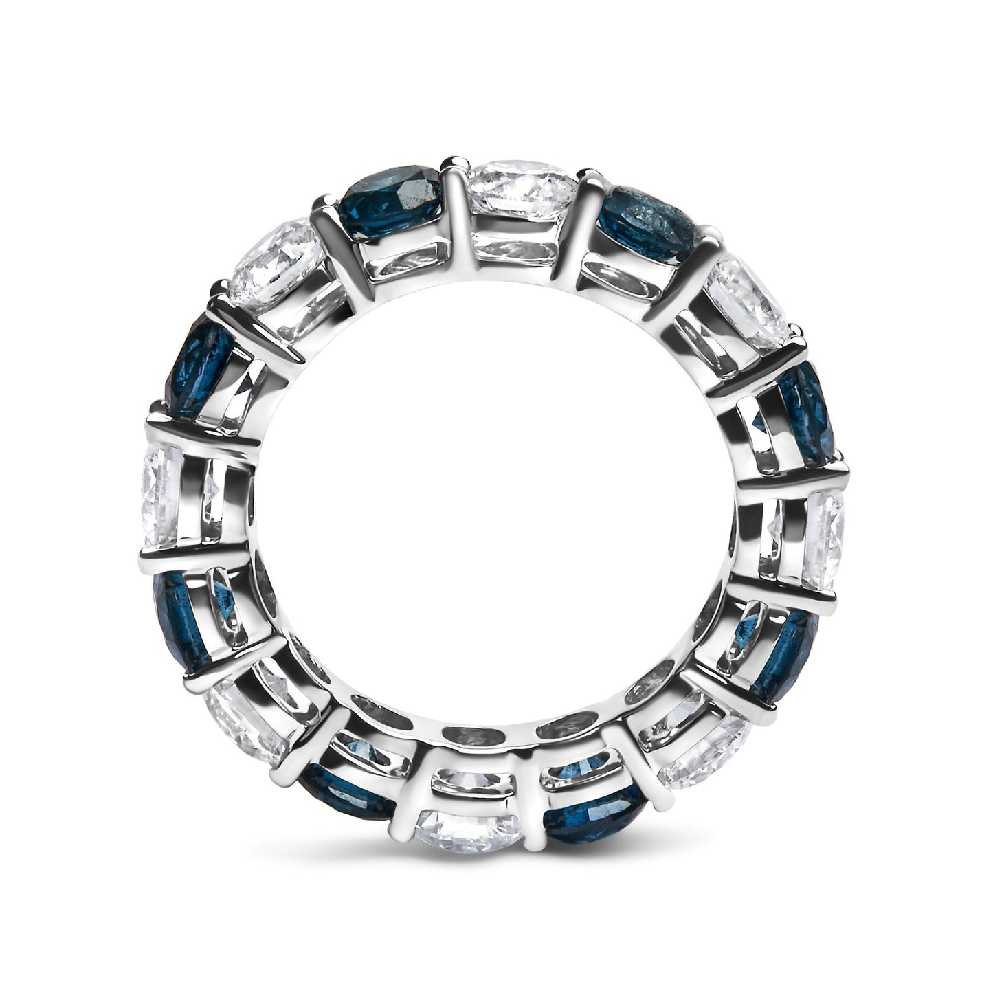 Top-down close-up of a white ring featuring alternating round blue and white gemstones in a shared prong setting.