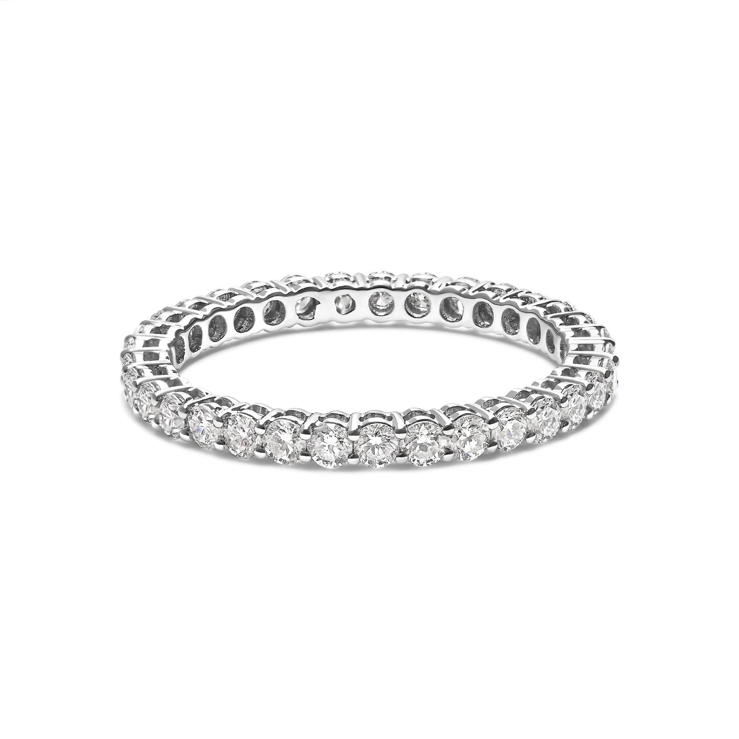 White metal ring with round white gemstones in shared prong setting, shown at a slight angle on a white background.