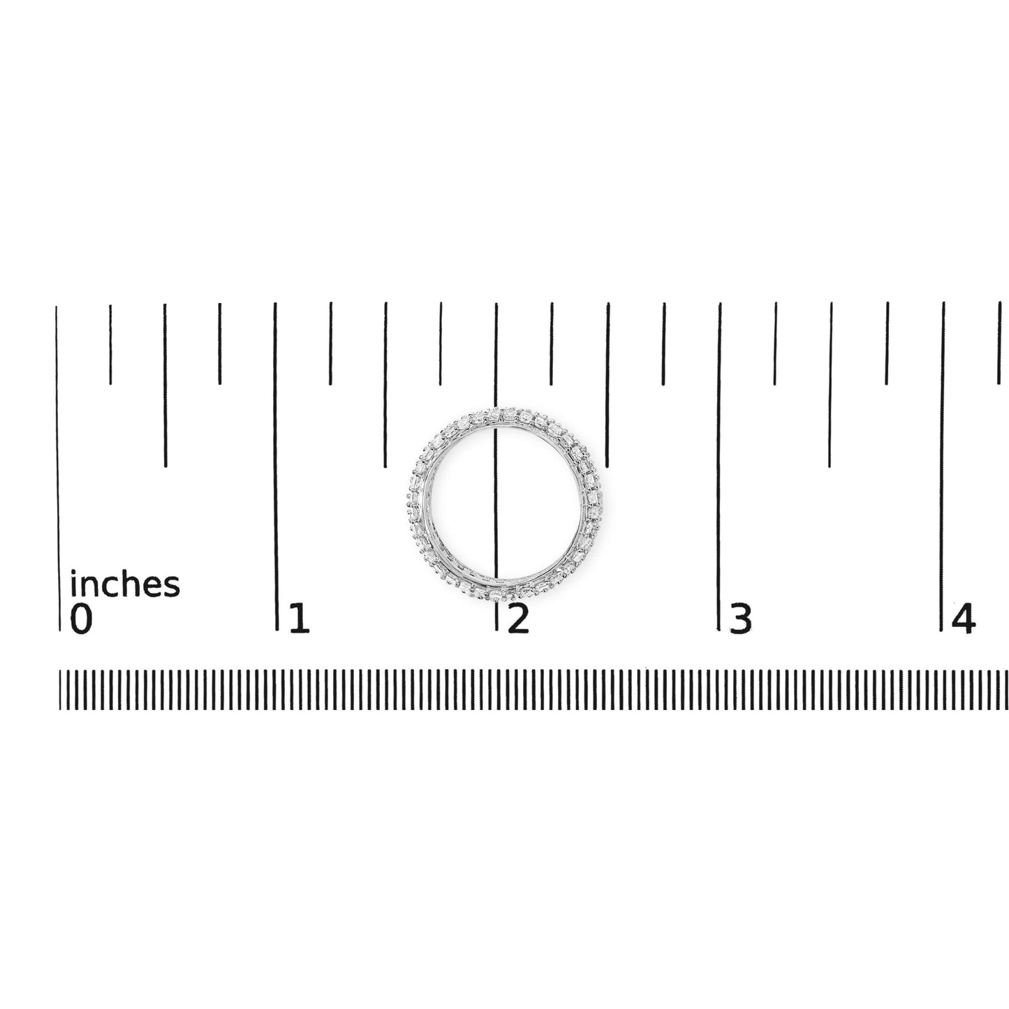 Top-down view of a white ring with princess-shaped white gemstones set in prongs, shown on a ruler scale.