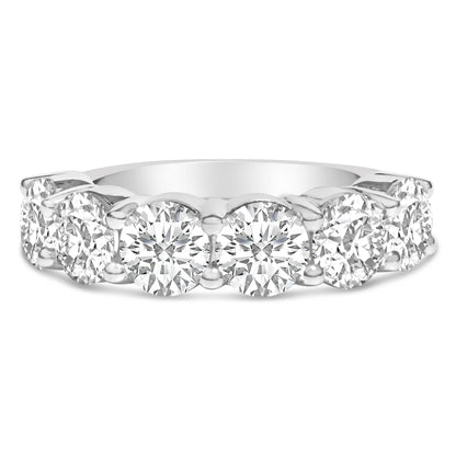 Close-up front view of a white ring featuring a row of round white gemstones set in a shared prong setting.