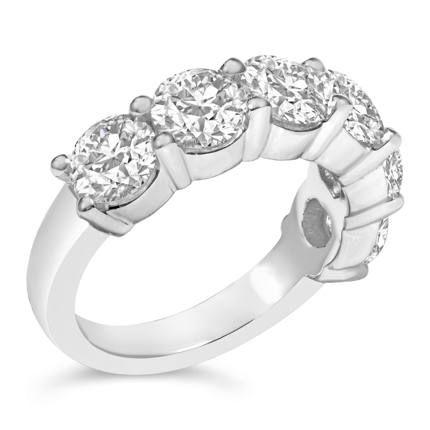 Close-up angled view of a white metal ring featuring six round white gemstones in a shared prong setting.
