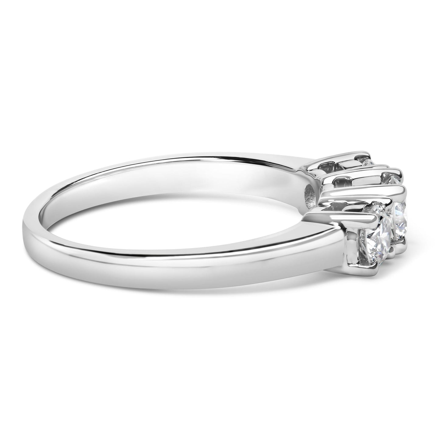 Side angle view of a white metal ring featuring three round white gemstones set in 4-prong settings.