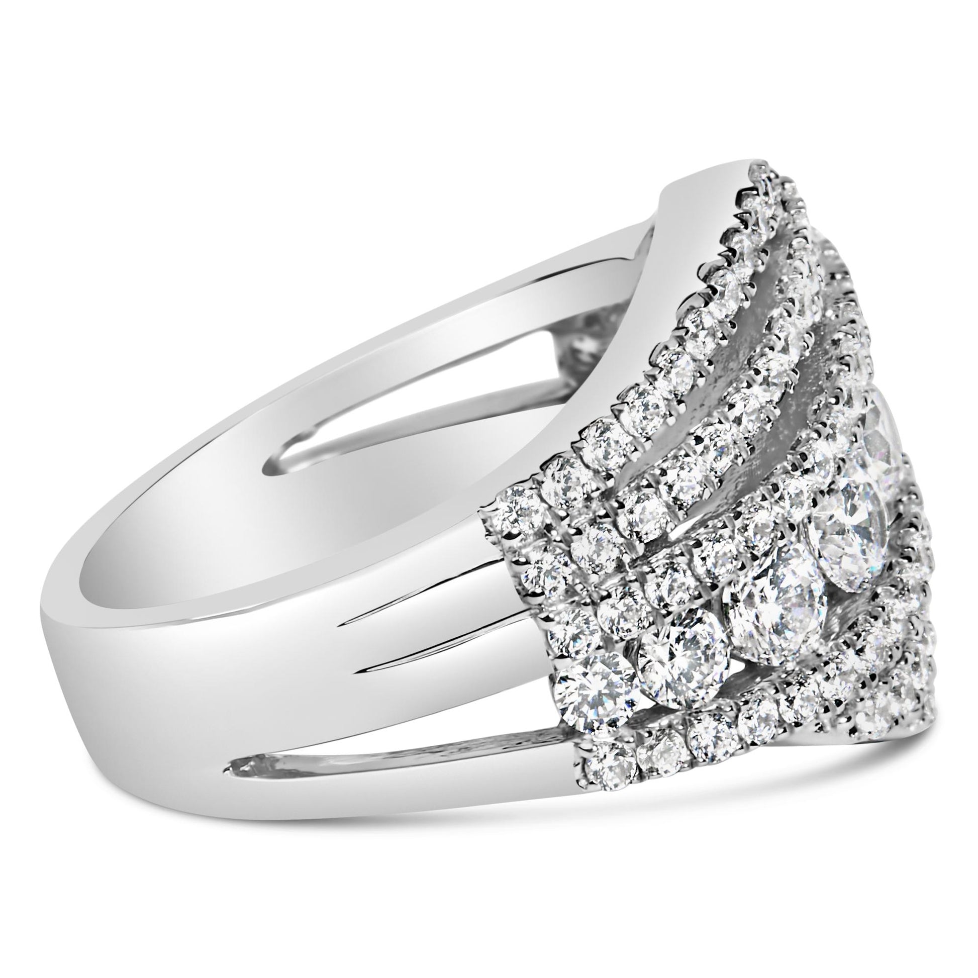 Close-up front angle of a white metal ring featuring a wide band split into sections, adorned with multiple round white gemstones in prong settings arranged in rows on the top.