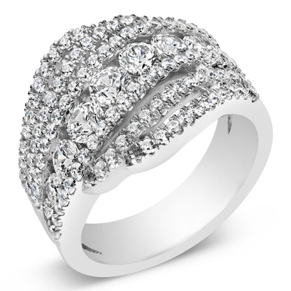 Close-up angled view of a white ring featuring multiple rows of round white gemstones in prong settings, including larger gemstones centrally placed and smaller ones surrounding them.