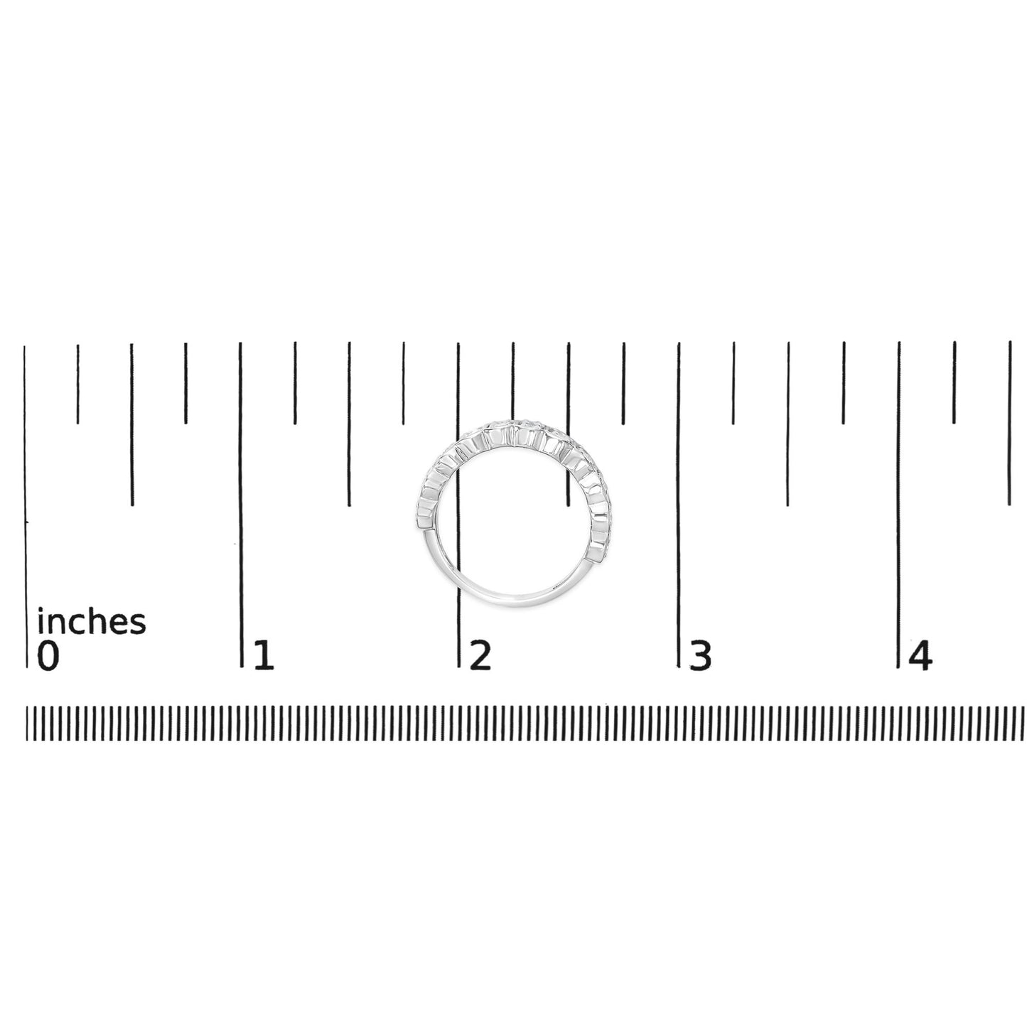 Top-down view of a white ring set with multiple round white gemstones in prong settings, shown on a measurement scale.