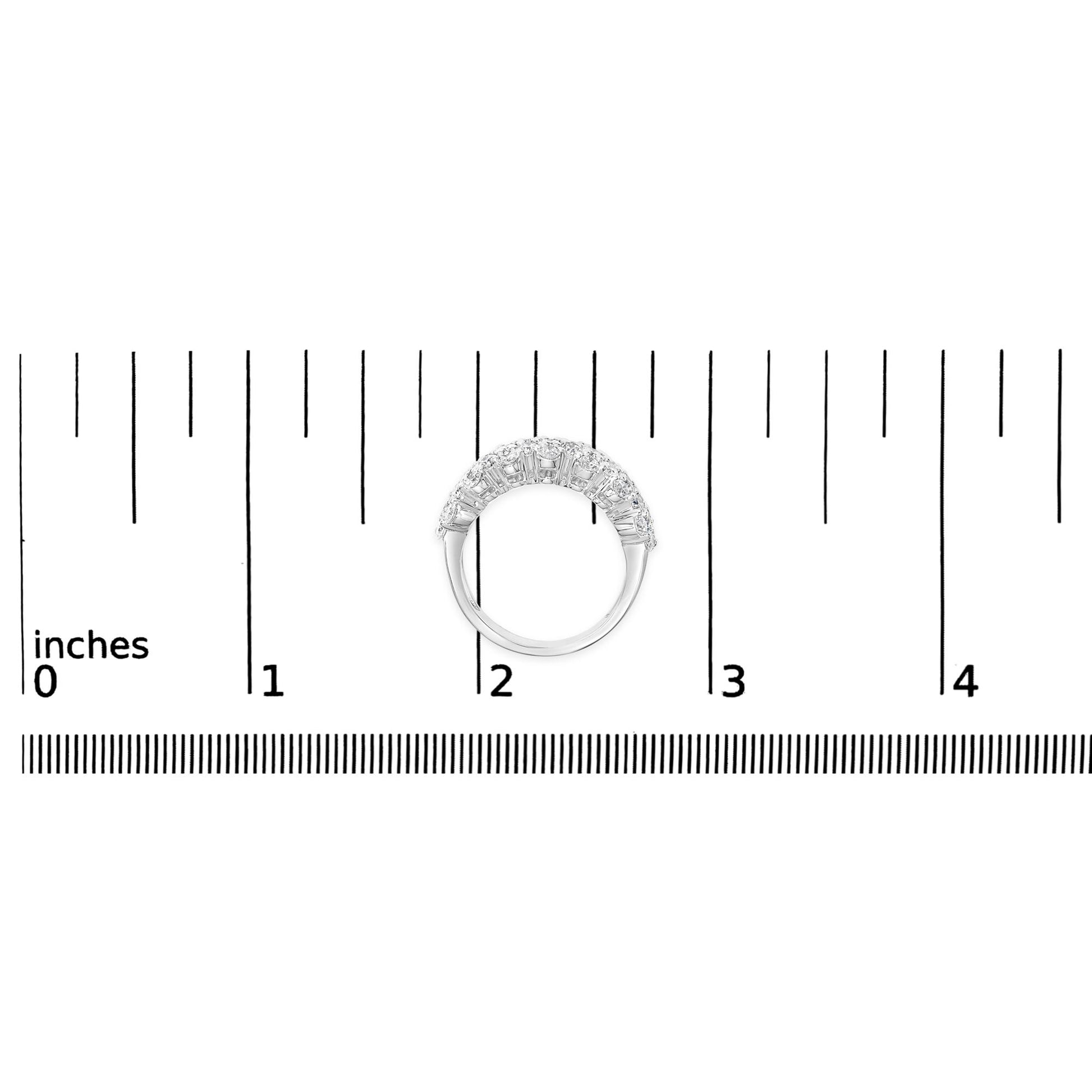 White metal ring with two rows of round white gemstones in prong settings, shown from a top angle on a measurement scale.