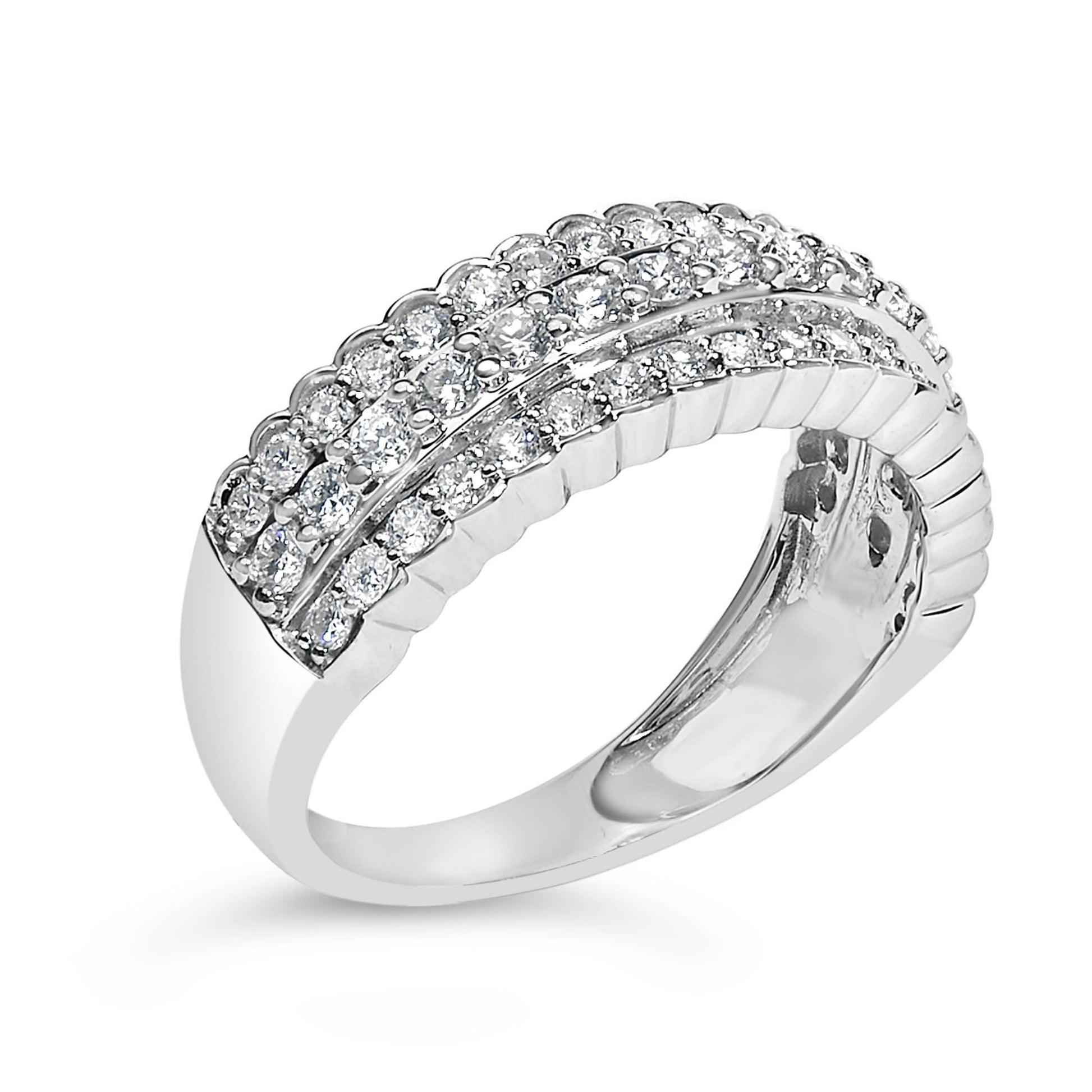 White metal ring with three rows of round white gemstones in prong settings, shown at a slight angle.