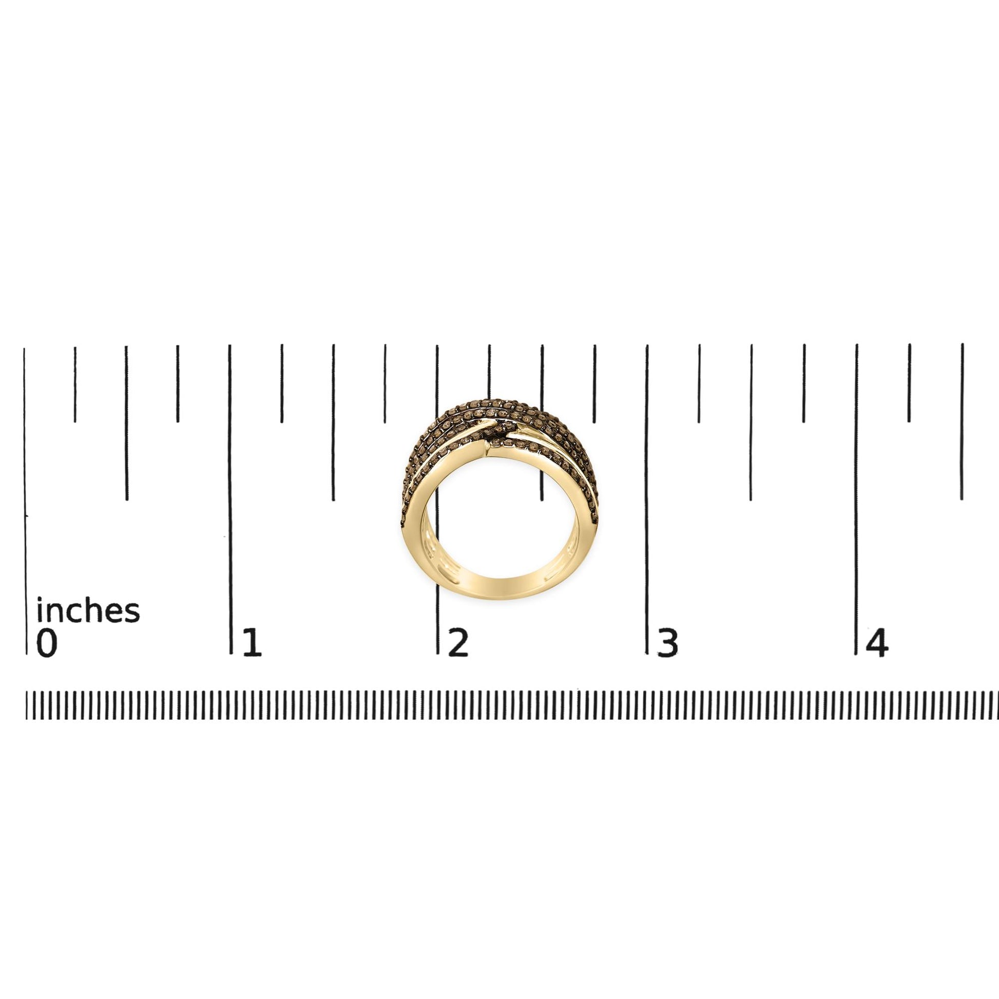 Yellow metal ring with multiple bands set with champagne-colored round gemstones in prong settings, shown from the front on a scale.