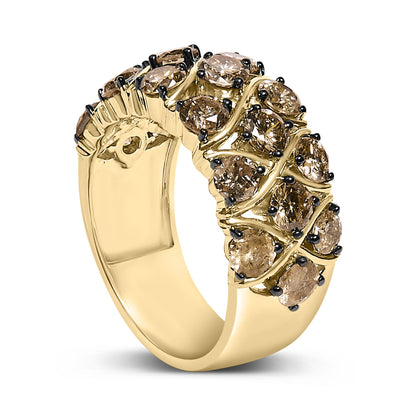 Close-up angled view of a yellow metal ring featuring multiple round champagne-colored gemstones in prong settings arranged in a swirling pattern across the band.