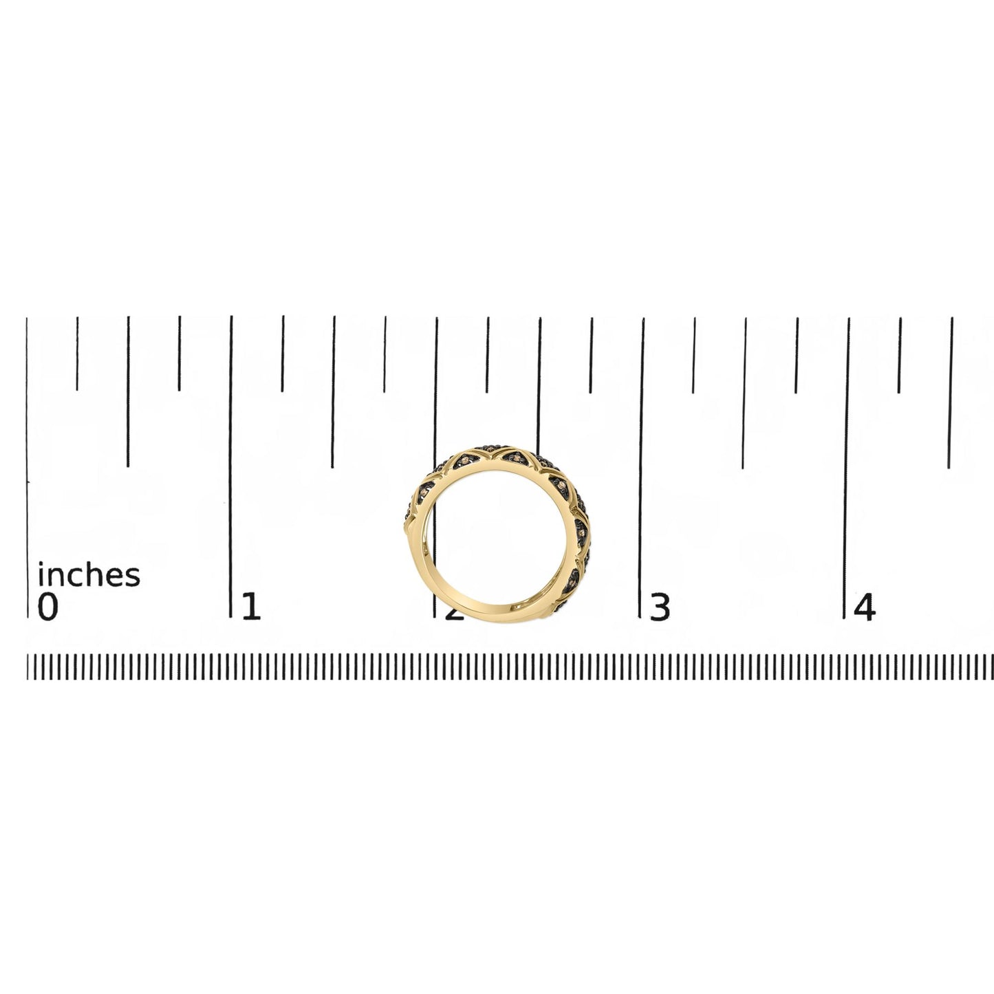Yellow metal ring with round champagne-colored gemstones in prong settings, shown on a ruler scale from a top-down angle.