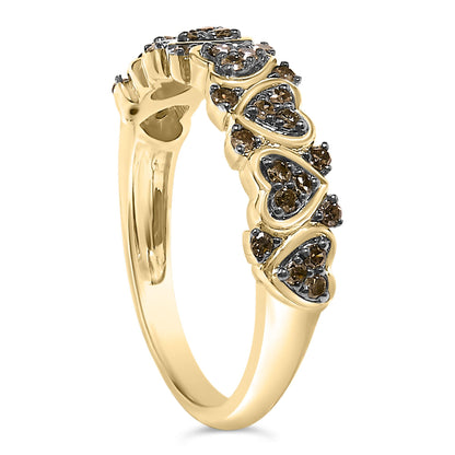 Yellow metal ring with heart-shaped clusters of round champagne-colored gemstones in prong settings, shown in a side angle.