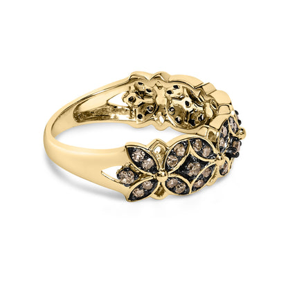 Yellow metal ring with floral and leaf shapes adorned with round champagne-colored gemstones in prong settings, shown in a close-up side angle.