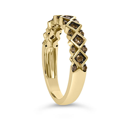 Close-up angled view of a yellow metal ring featuring alternating square settings with larger champagne-colored round gemstones surrounded by smaller champagne-colored round gemstones in prong settings.