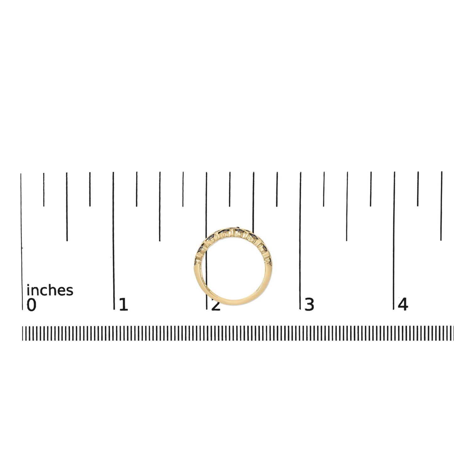 Yellow metal ring with round champagne-colored gemstones in prong settings, shown on a scale from a top-down angle.