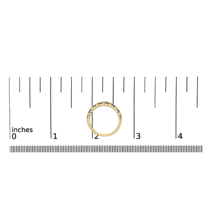 Yellow metal ring with round champagne-colored gemstones in prong settings, shown on a scale from a top-down angle.