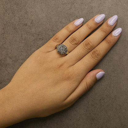 Yellow metal ring with multiple round champagne-colored gemstones in prong settings, shown worn on a model's hand, top-down angle.