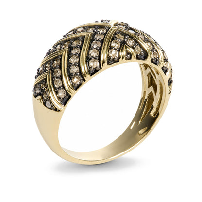 Close-up image of a yellow ring with a zigzag pattern encrusted with round champagne-colored gemstones in prong settings, shown at an angle.