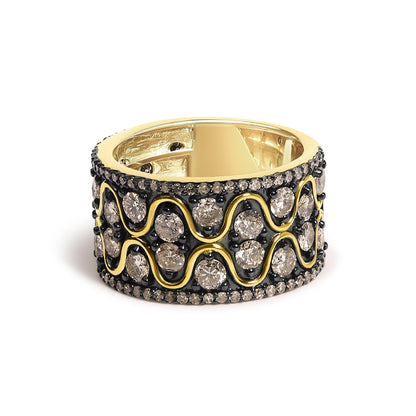 Close-up front angle of a wide yellow metal ring featuring an intricate design with prong-set round champagne-colored gemstones and black enamel accents.