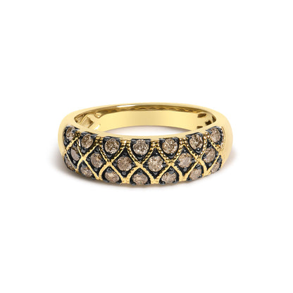 Close-up front angle of a yellow ring featuring round champagne-colored gemstones in prong settings arranged in a patterned design.