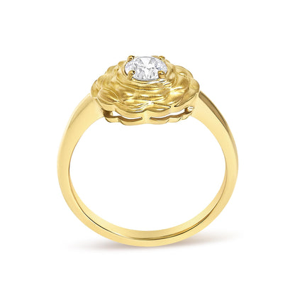 Close-up front angle of a yellow ring with a round white gemstone in a four-prong setting on a textured flower-shaped design.